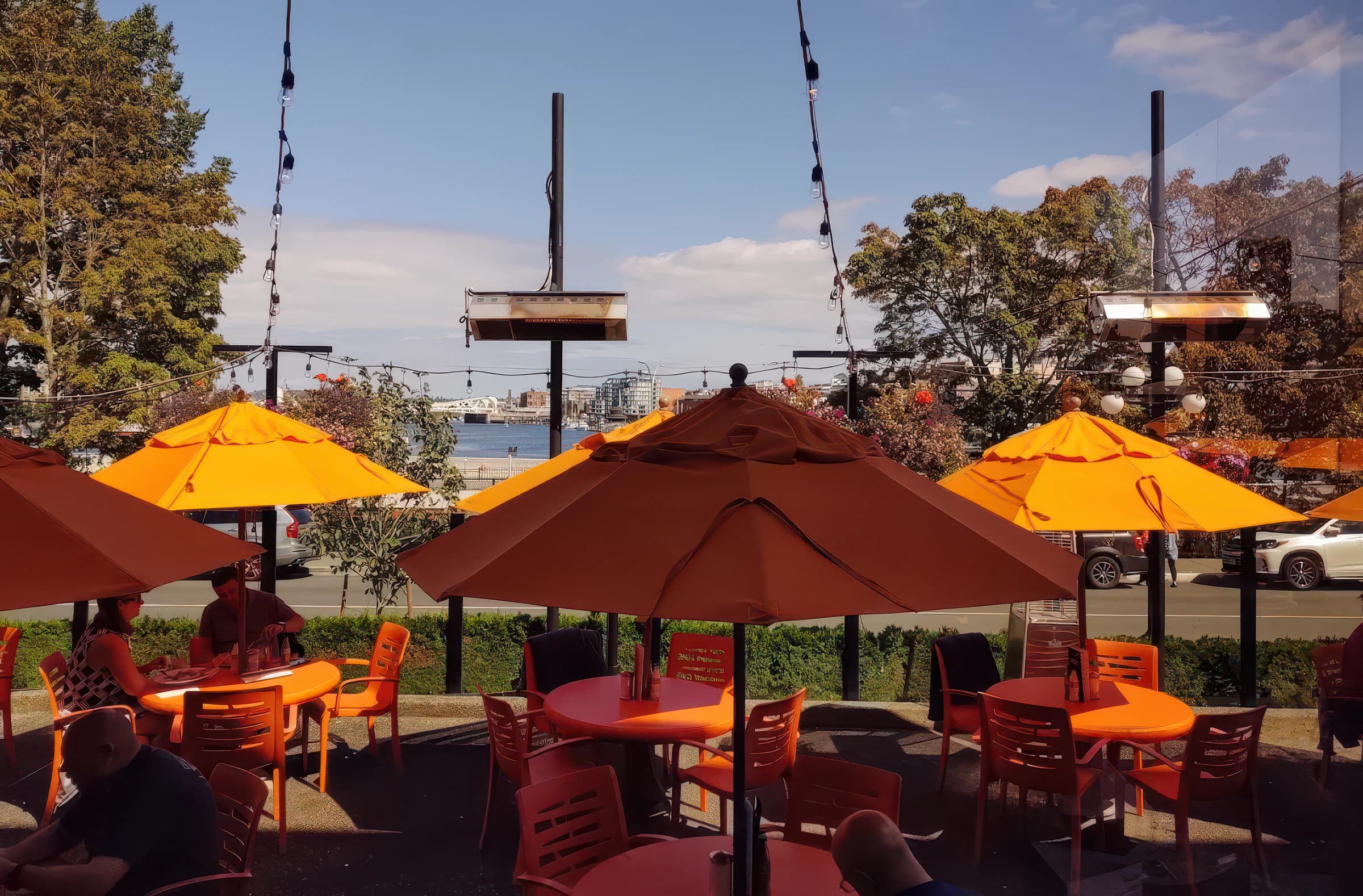 Belleville's patio with orange umbrellas overlooking Victoria's Inner Harbour